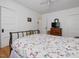 Comfortable bedroom featuring a decorative metal bed frame, floral bedding, and a TV on a dresser at 224 E Park Dr, Raleigh, NC 27605