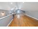 Bonus Room featuring hardwood floors, neutral paint, built-in shelves, and lots of natural light at 224 E Park Dr, Raleigh, NC 27605