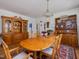 Elegant dining room with wood table and chairs, decorative hutch, and hardwood floors at 224 E Park Dr, Raleigh, NC 27605
