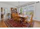 Bright dining room featuring natural light, wood table with chairs, and decorative china hutch at 224 E Park Dr, Raleigh, NC 27605