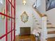 Inviting entryway featuring hardwood floors, an ornate mirror, and a staircase with white banisters at 224 E Park Dr, Raleigh, NC 27605