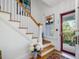 Welcoming entryway featuring a red door, a stained-glass window and hardwood flooring at 224 E Park Dr, Raleigh, NC 27605