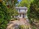 Charming home featuring a brick patio with outdoor seating and a meticulously landscaped yard at 224 E Park Dr, Raleigh, NC 27605