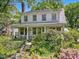 Charming two-story home with a welcoming front porch and lush, landscaped garden at 224 E Park Dr, Raleigh, NC 27605