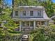 Inviting home featuring a covered front porch perfect for relaxing and enjoying the beautifully landscaped surroundings at 224 E Park Dr, Raleigh, NC 27605