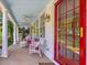 Front porch with red door, inviting seating, and a light blue ceiling, perfect for relaxing at 224 E Park Dr, Raleigh, NC 27605