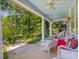 Inviting front porch with wicker furniture and a ceiling fan, perfect for enjoying outdoor living space at 224 E Park Dr, Raleigh, NC 27605