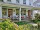 Cozy front porch furnished with wicker seating, ideal for enjoying the outdoors in style at 224 E Park Dr, Raleigh, NC 27605