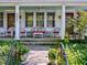 Inviting front porch with cozy wicker furniture, perfect for relaxing and enjoying the neighborhood views at 224 E Park Dr, Raleigh, NC 27605