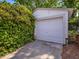 View of detached one car garage surrounded by mature trees at 224 E Park Dr, Raleigh, NC 27605