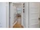 Hallway featuring hardwood floors and paneled doors leading to various rooms at 224 E Park Dr, Raleigh, NC 27605