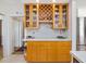 Kitchen area features display cabinets with wine storage above countertops and classic wood cabinetry at 224 E Park Dr, Raleigh, NC 27605
