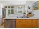 Well-lit kitchen featuring stainless steel appliances, practical layout and tile flooring at 224 E Park Dr, Raleigh, NC 27605