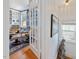 A glimpse of a living room featuring built-in bookshelves and a comfortable chair, accessible through elegant French doors at 224 E Park Dr, Raleigh, NC 27605