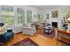 Bright living room with a fireplace, built-in shelves, and large windows offering natural light at 224 E Park Dr, Raleigh, NC 27605