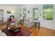 Bright and airy living room with multiple windows and comfortable seating arrangement at 224 E Park Dr, Raleigh, NC 27605