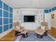 Cozy living room features a TV, built-in shelving, hardwood floors, and comfortable leather chairs at 224 E Park Dr, Raleigh, NC 27605