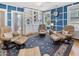Inviting living room with blue accent walls, built-in shelves, and comfortable leather seating arranged around a patterned rug at 224 E Park Dr, Raleigh, NC 27605