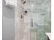 Close-up of a tiled walk-in shower with glass doors, showcasing the modern design and sleek fixtures at 224 E Park Dr, Raleigh, NC 27605