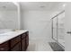 Bathroom featuring a dual sink vanity with sleek countertops, a shower with glass door, and tile flooring at 230 Purple Aster St St, Youngsville, NC 27596