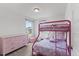 Bright bedroom featuring a pink bunk bed, matching dresser, and a cozy atmosphere with natural light at 230 Purple Aster St St, Youngsville, NC 27596