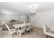 Bright dining area with hardwood floors that opens up to a comfortable living space with neutral colored furniture at 230 Purple Aster St St, Youngsville, NC 27596