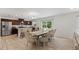 Bright dining area showcasing an open layout with hardwood floors and updated kitchen with stainless steel appliances at 230 Purple Aster St St, Youngsville, NC 27596