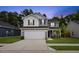 Charming two-story home featuring a two-car garage, a well-manicured lawn, and gray siding under a twilight sky at 230 Purple Aster St St, Youngsville, NC 27596