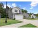 Modern two-story home featuring gray siding, a two-car garage, and a well-manicured front lawn at 230 Purple Aster St St, Youngsville, NC 27596
