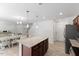 Contemporary kitchen with granite counters and island, flowing into dining and living areas for an open, airy feel at 230 Purple Aster St St, Youngsville, NC 27596