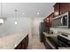 Modern kitchen with stainless appliances, granite counters, and center island with seating that opens up to dining at 230 Purple Aster St St, Youngsville, NC 27596