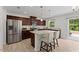 Modern kitchen featuring stainless steel appliances, granite countertops, and a convenient center island with seating at 230 Purple Aster St St, Youngsville, NC 27596