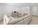 Cozy living room with a large sectional sofa, decorative accents, and a glass coffee table, creating a welcoming atmosphere at 230 Purple Aster St St, Youngsville, NC 27596