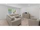 Bright living room featuring a comfortable sectional sofa and contemporary decor, perfect for relaxing and entertaining at 230 Purple Aster St St, Youngsville, NC 27596