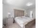 Spacious main bedroom featuring a decorative headboard and matching nightstands with lamps, providing a serene retreat at 230 Purple Aster St St, Youngsville, NC 27596