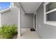 Inviting front porch with neutral gray siding, white trim, a 'hello' welcome mat and modern accents at 230 Purple Aster St St, Youngsville, NC 27596