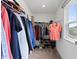Organized walk-in closet with shelving, hanging racks, and a window, offering ample storage space at 230 Purple Aster St St, Youngsville, NC 27596
