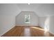 Finished attic with hardwood floors, natural light, neutral paint, and sloped ceilings at 2309 Clerestory Pl, Raleigh, NC 27615