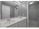 Modern bathroom with black and white striped wallpaper and a large double sink vanity at 2309 Clerestory Pl, Raleigh, NC 27615