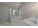 Bathroom features walk-in shower, soaking tub, and dual sinks with bright lighting at 2309 Clerestory Pl, Raleigh, NC 27615