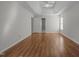 Spacious bedroom features a tray ceiling, hardwood floors, neutral paint, and a doorway at 2309 Clerestory Pl, Raleigh, NC 27615