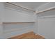 Walk-in closet has wooden racks and shelving for organized storage at 2309 Clerestory Pl, Raleigh, NC 27615