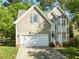 Charming two-story home with a two-car garage, manicured lawn, and beautiful architectural details at 2309 Clerestory Pl, Raleigh, NC 27615