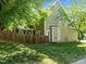 Exterior shot shows the side yard, back of the house, and fencing at 2309 Clerestory Pl, Raleigh, NC 27615