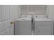 Functional laundry room featuring a washer and dryer with overhead storage at 2309 Clerestory Pl, Raleigh, NC 27615