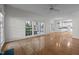 Bright living room features hardwood floors and large windows offering natural light at 2309 Clerestory Pl, Raleigh, NC 27615