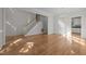 Open living area with hardwood floors, staircase, and chandelier, perfect for entertaining at 2309 Clerestory Pl, Raleigh, NC 27615