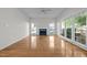 Well-lit living room with fireplace, hardwood floors, and large windows offering ample natural light at 2309 Clerestory Pl, Raleigh, NC 27615