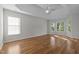 Main bedroom with hardwood floors, ample natural light, and ceiling fan at 2309 Clerestory Pl, Raleigh, NC 27615