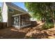 Exterior home view featuring a spacious screened porch and natural backyard at 2309 Clerestory Pl, Raleigh, NC 27615